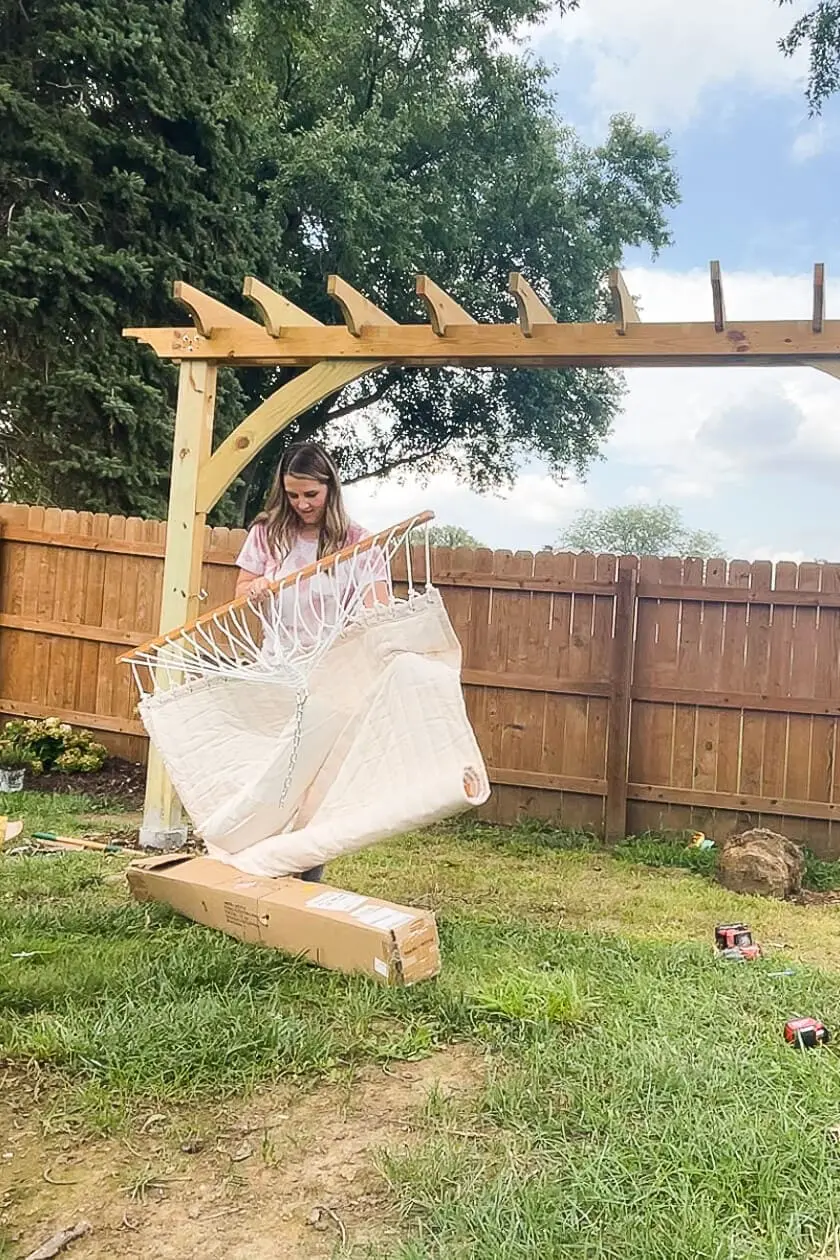 Hanging a hammock in the backyard.